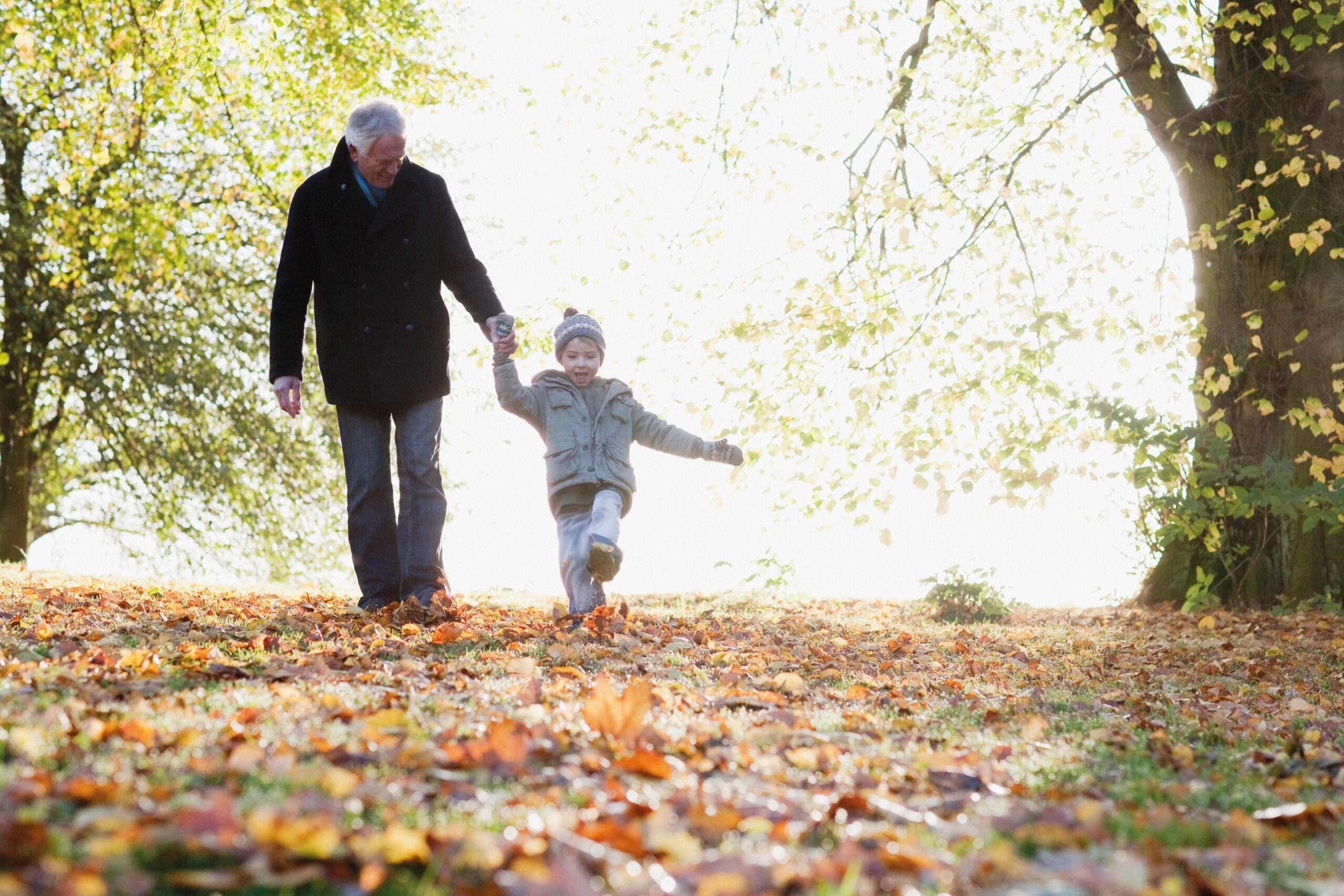 Grandfather and child walking in woods