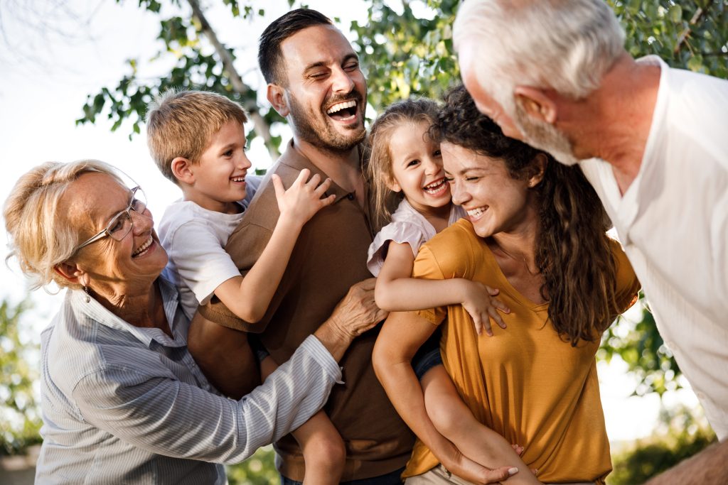 Multi generational family outside laughing
