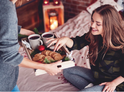 A young lady eating a Christmas snack