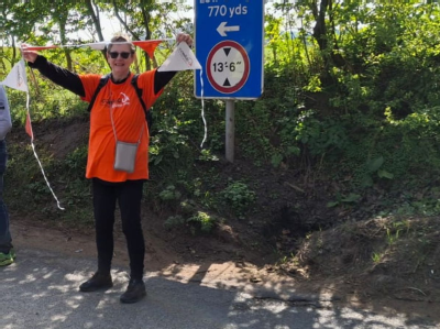 Brenda with orange Coeliac Uk t-shirt and bunting, supporting her fellow volunteers.